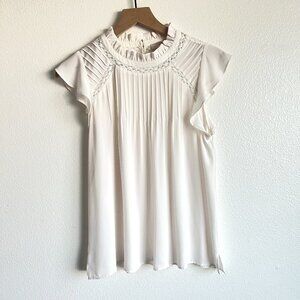 Intricate White Sleeveless Blouse